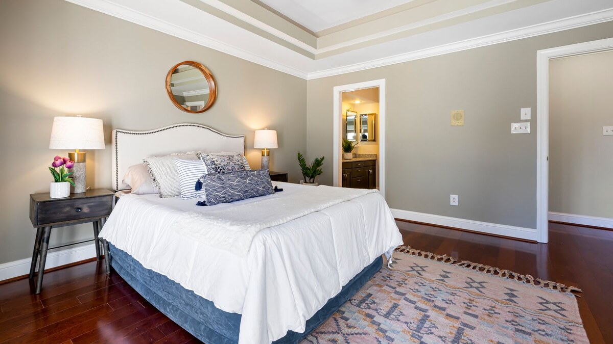 A soft plush rug framing the foot of a bed in a small bedroom
